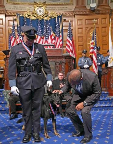 Ashland Police Officer Christopher E. Alberini along with his partner Dax were awarded the Medal Of Valor. Governor Patrick gave Dax a pat on the head.  Photo by:  David L Ryan/Globe Staff